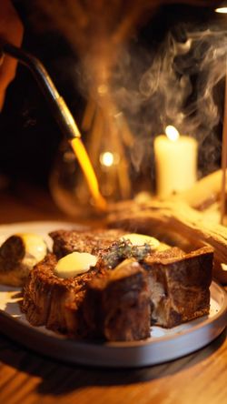 Grilled steak with melted butter served with mushrooms in a fine dining restaurant setting at Mēdüzā Mediterrania New York.